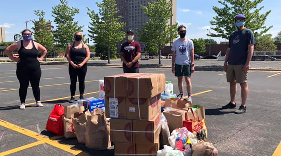 Students and staff in parking lot L gathering supplies to donate